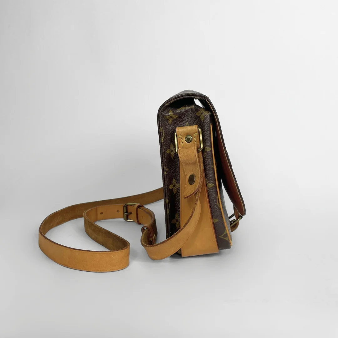 A vintage Louis Vuitton shoulder bag in brown monogram canvas with tan leather trim and strap, shown from a side profile view on a light gray background.