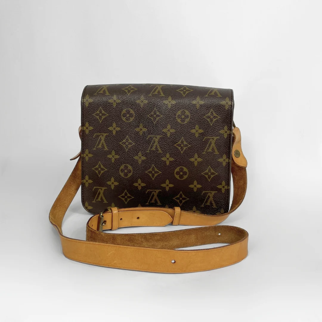 A vintage Louis Vuitton monogram canvas shoulder bag with a tan leather strap, displayed on a light gray background.