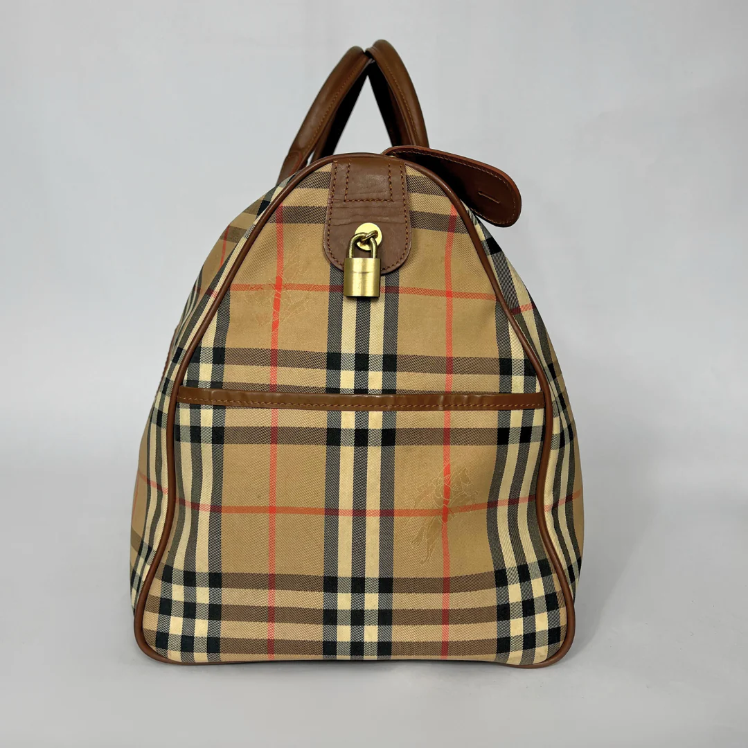Plaid backpack with brown leather accents on a light gray background