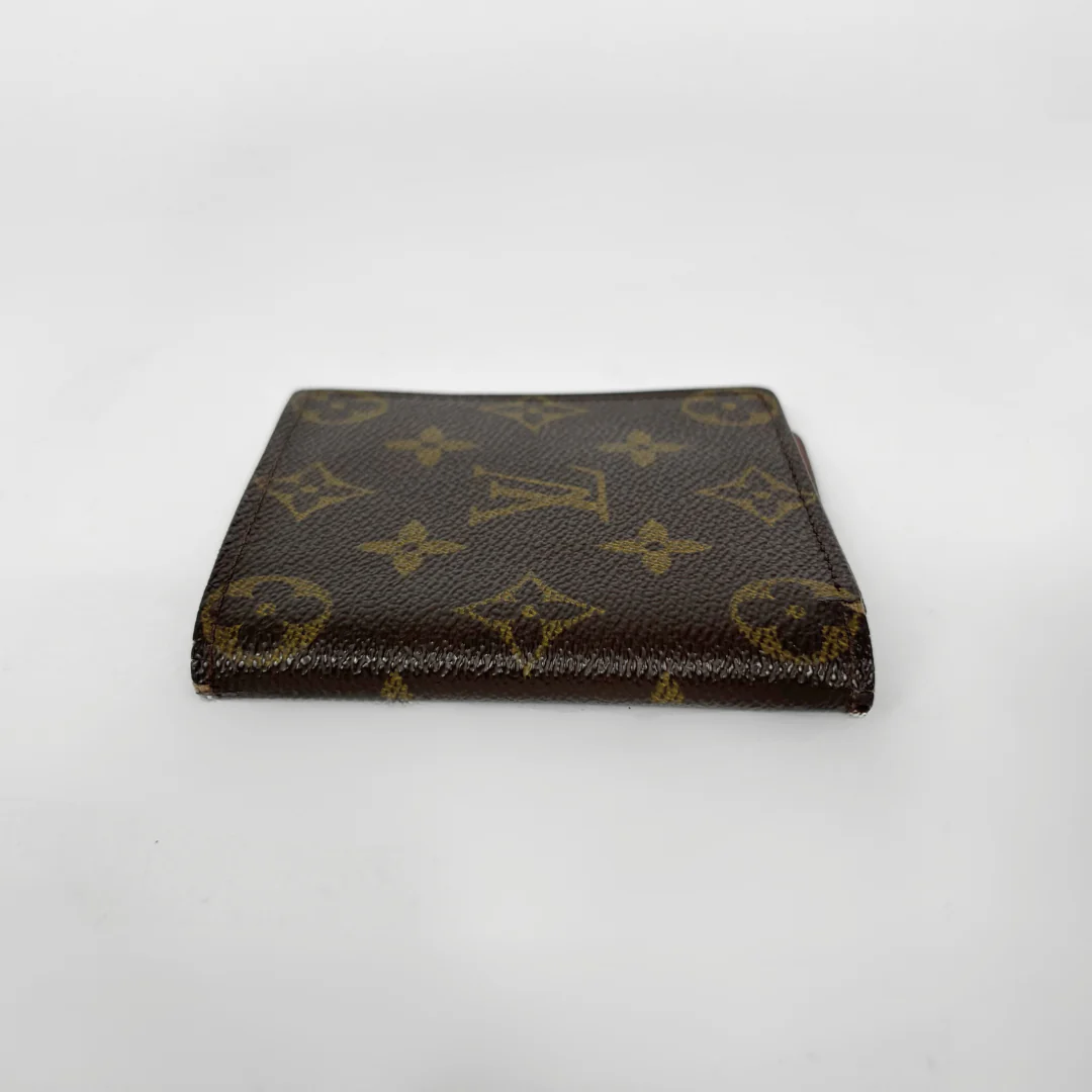 Louis Vuitton wallet with monogram pattern on a white background