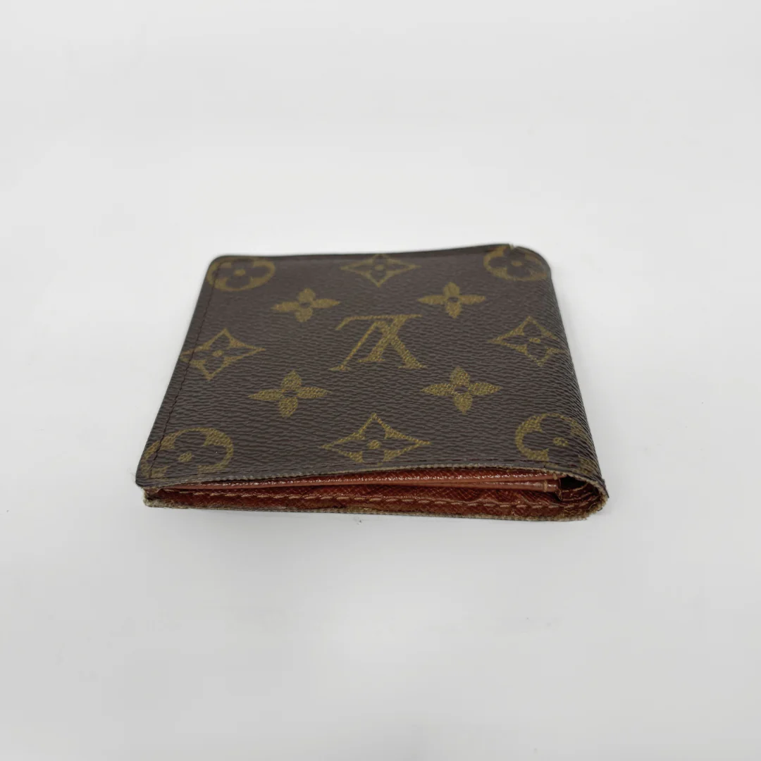Brown wallet with monogram pattern on a white background
