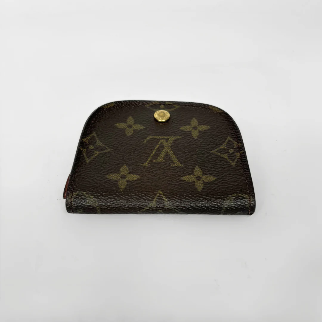 Louis Vuitton wallet with monogram pattern on a white background