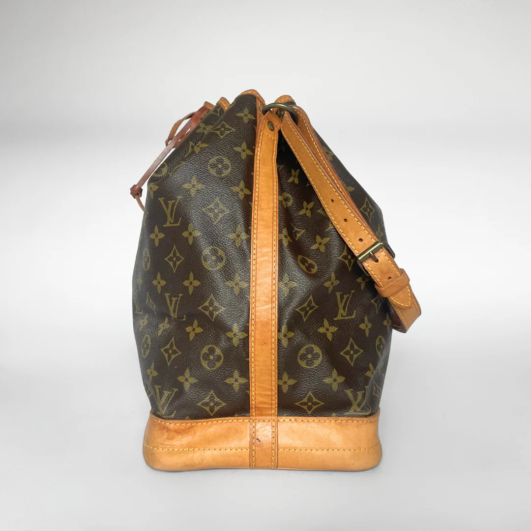 Designer handbag with monogram pattern on a white background