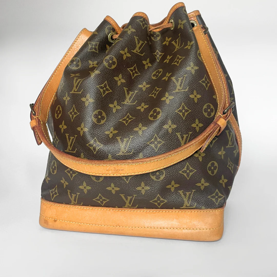 Designer handbag with monogram pattern on a white background