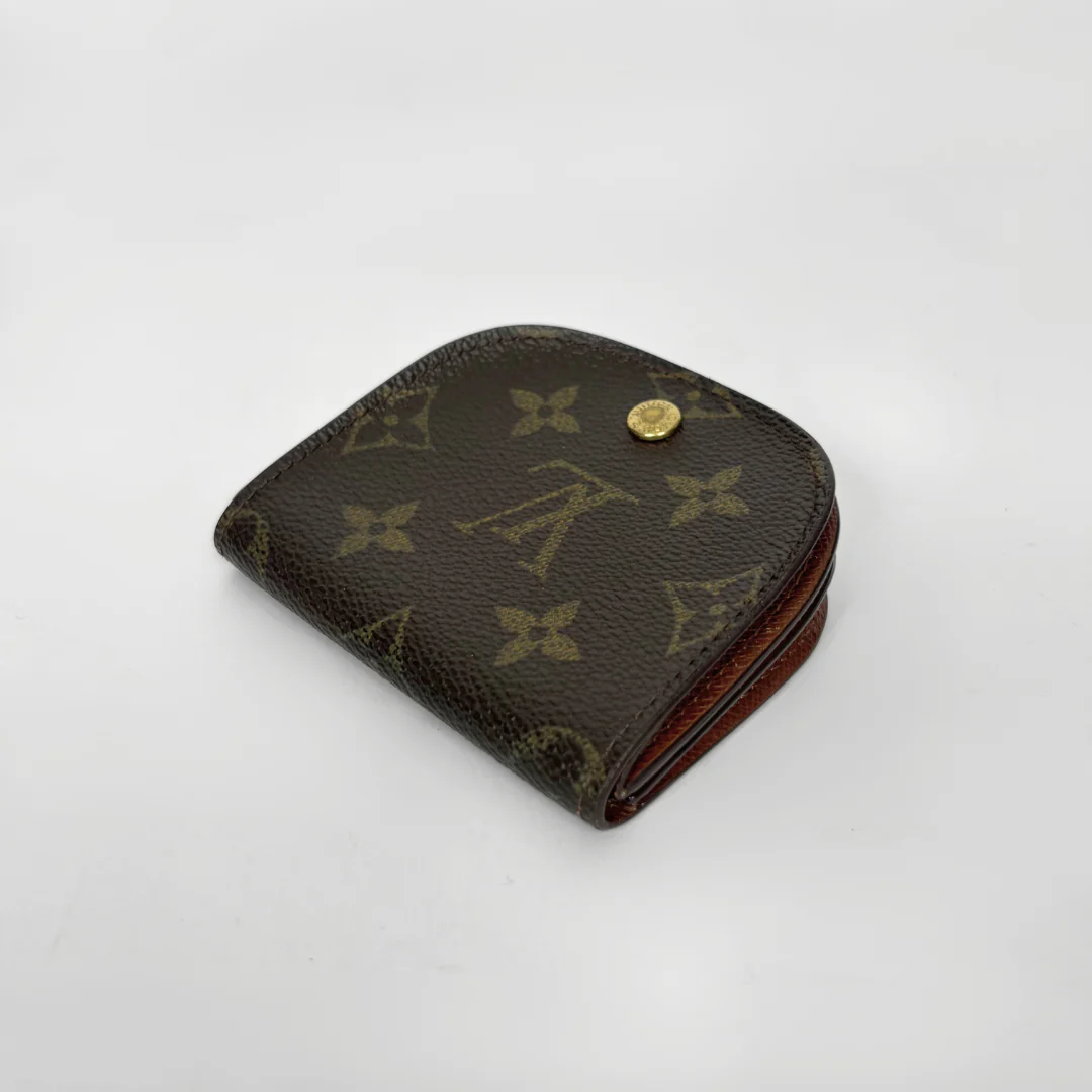 Louis Vuitton wallet with monogram pattern on a white background