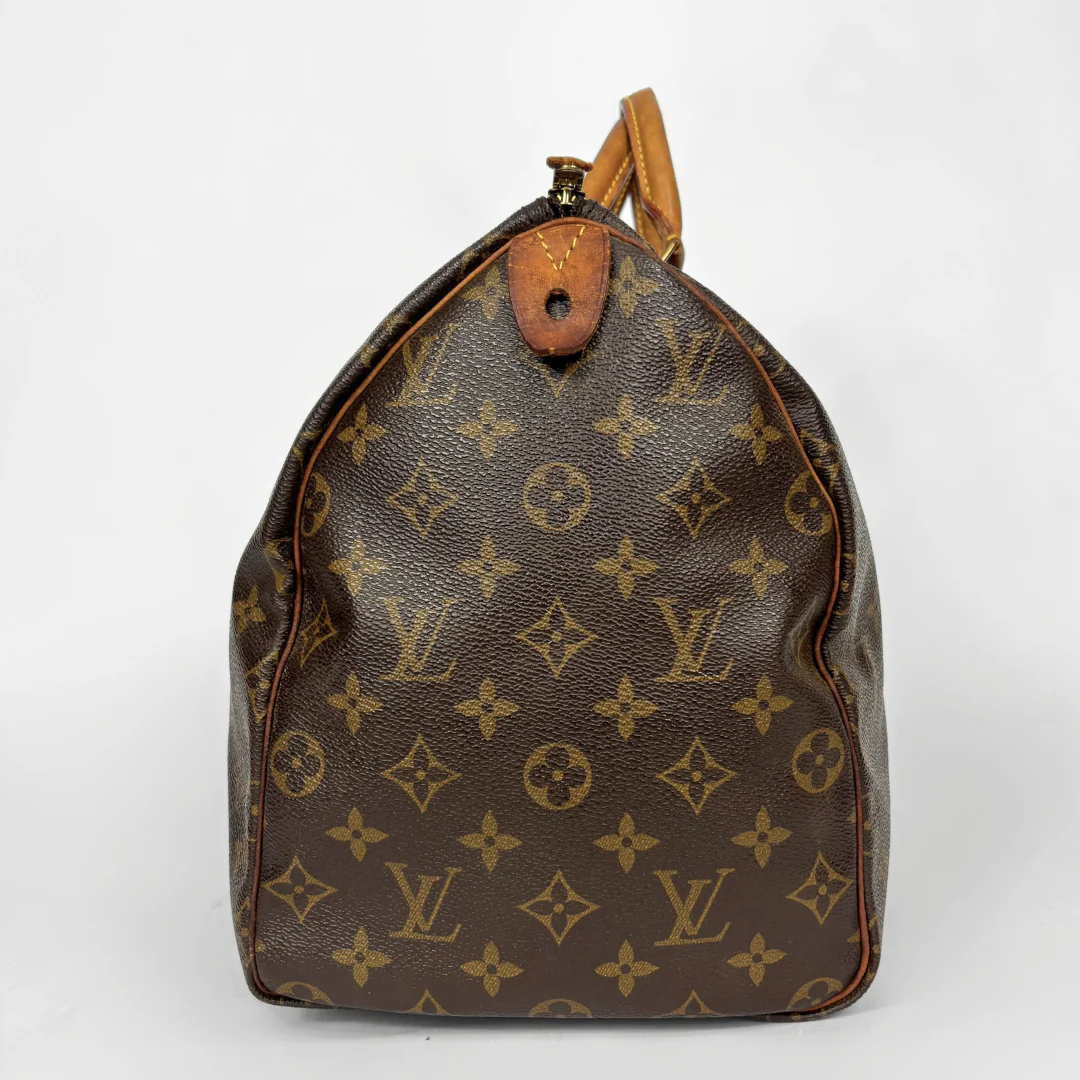 Brown Louis Vuitton bag with monogram pattern on a white background