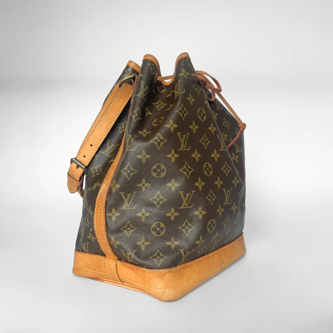 Designer handbag with monogram pattern on a white background