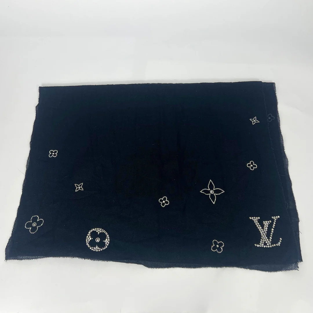 Black scarf with embroidered patterns on a white background