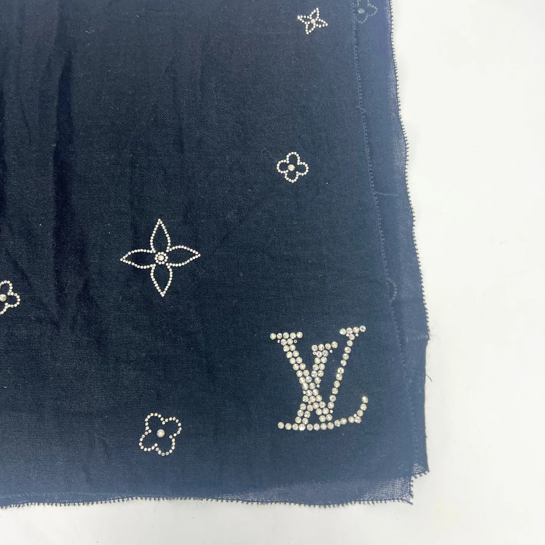 Navy blue fabric with embroidered logos on a white background