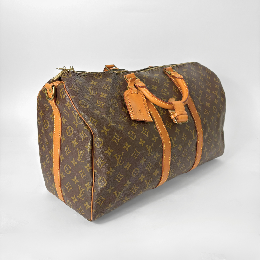 Brown travel bag with orange accents on a white background