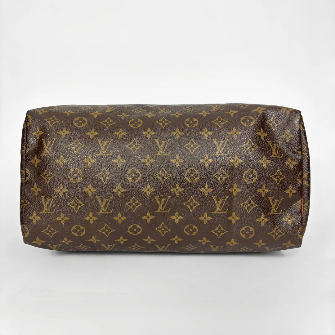 Brown Louis Vuitton bag with monogram pattern on a white background