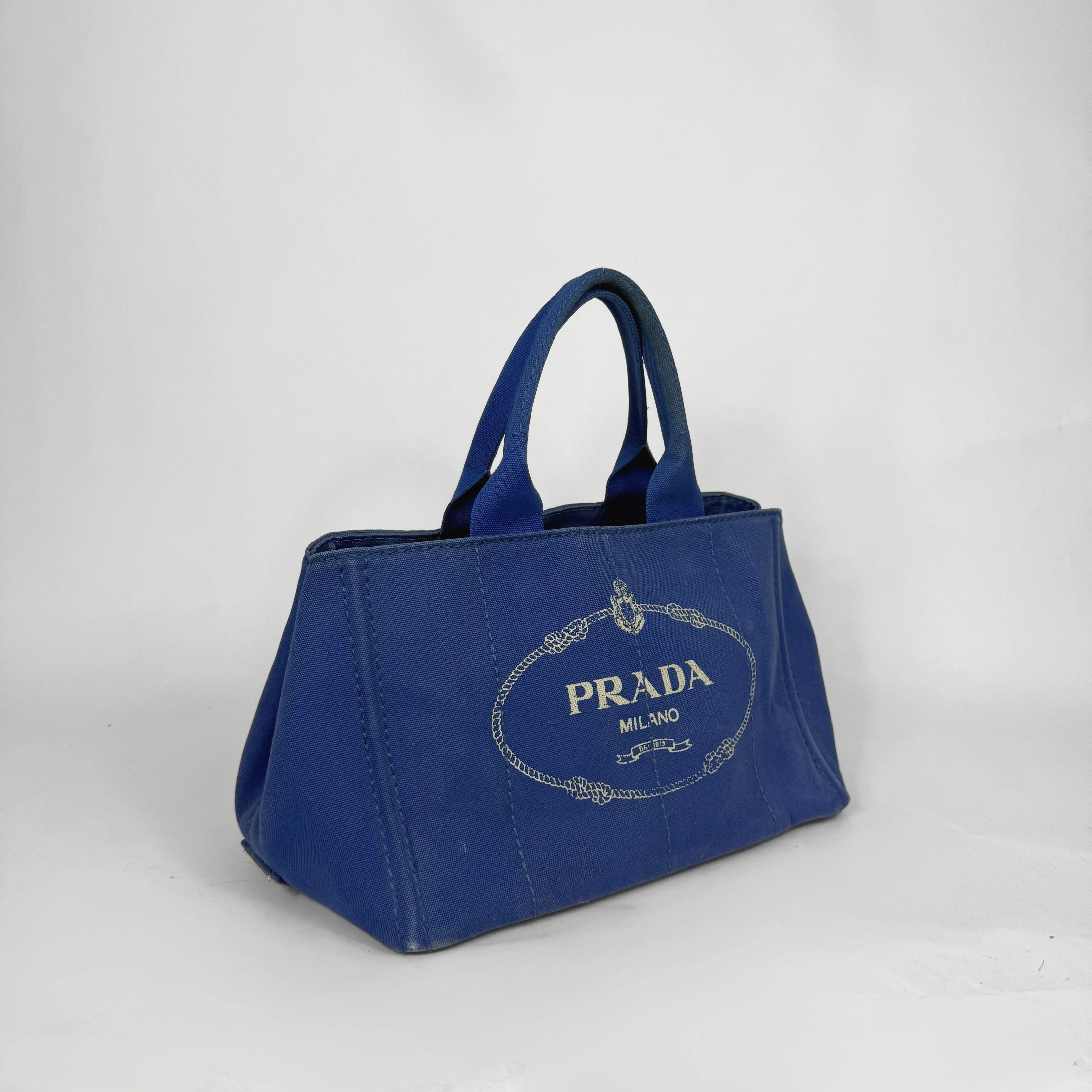 Blue Prada handbag on a white background