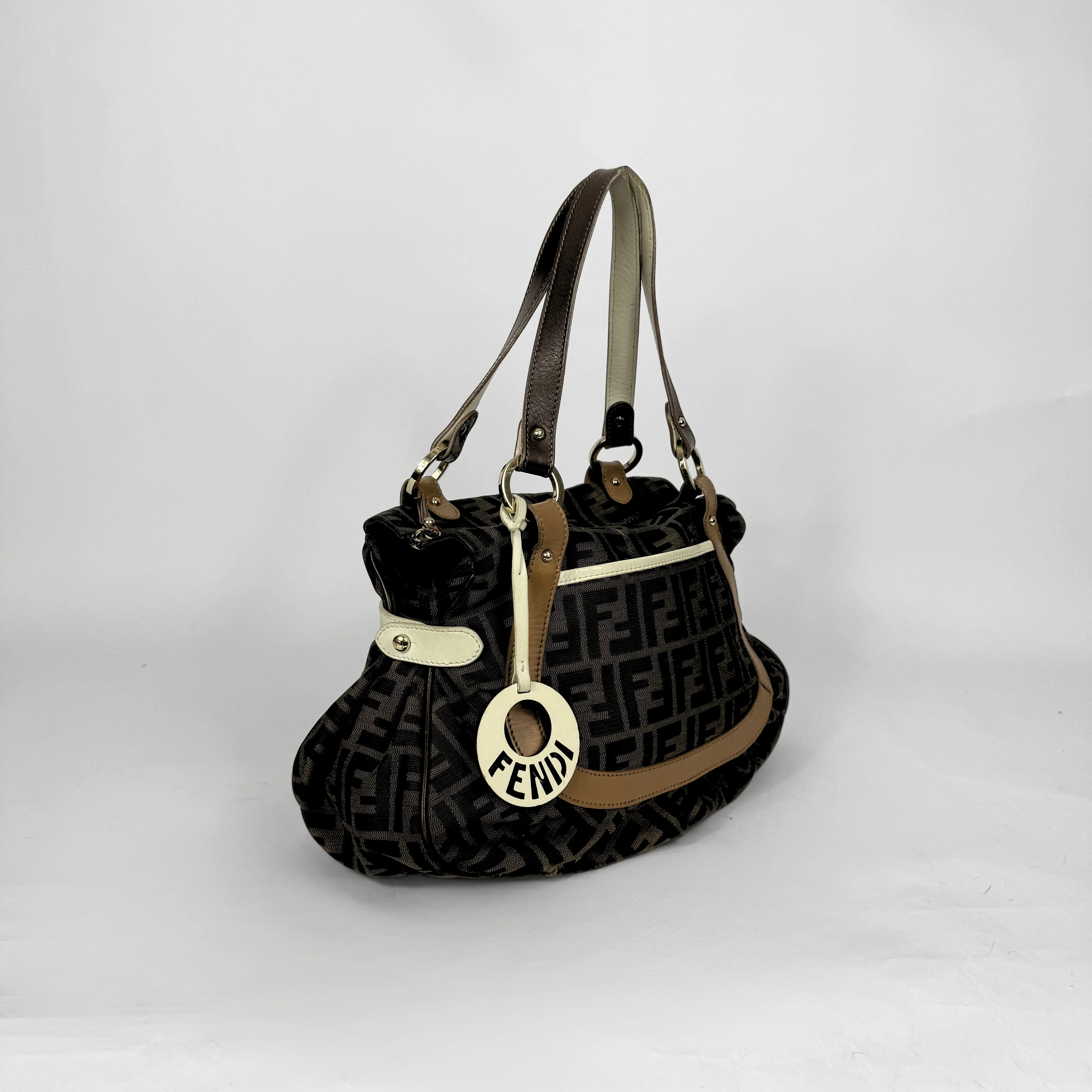 Fendi Zucca monogram canvas shoulder bag with letaher trim and a large white cicular FENDI charm.