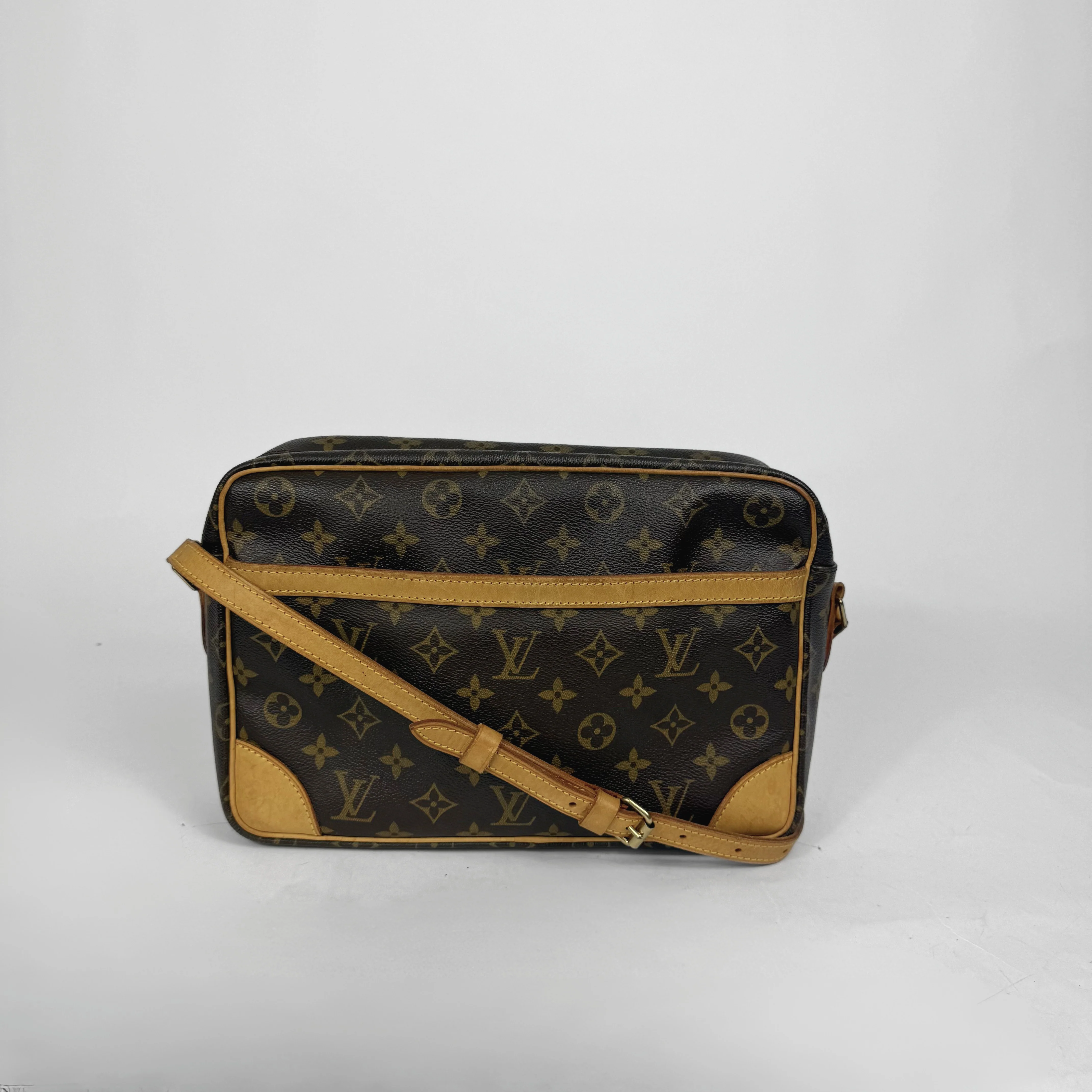 Designer handbag with monogram pattern on a white background