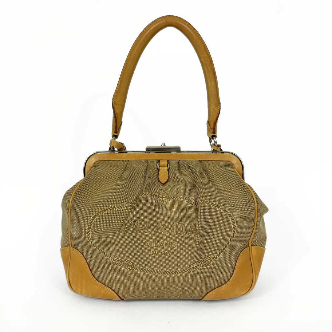 Prada handbag with brown leather accents on a white background