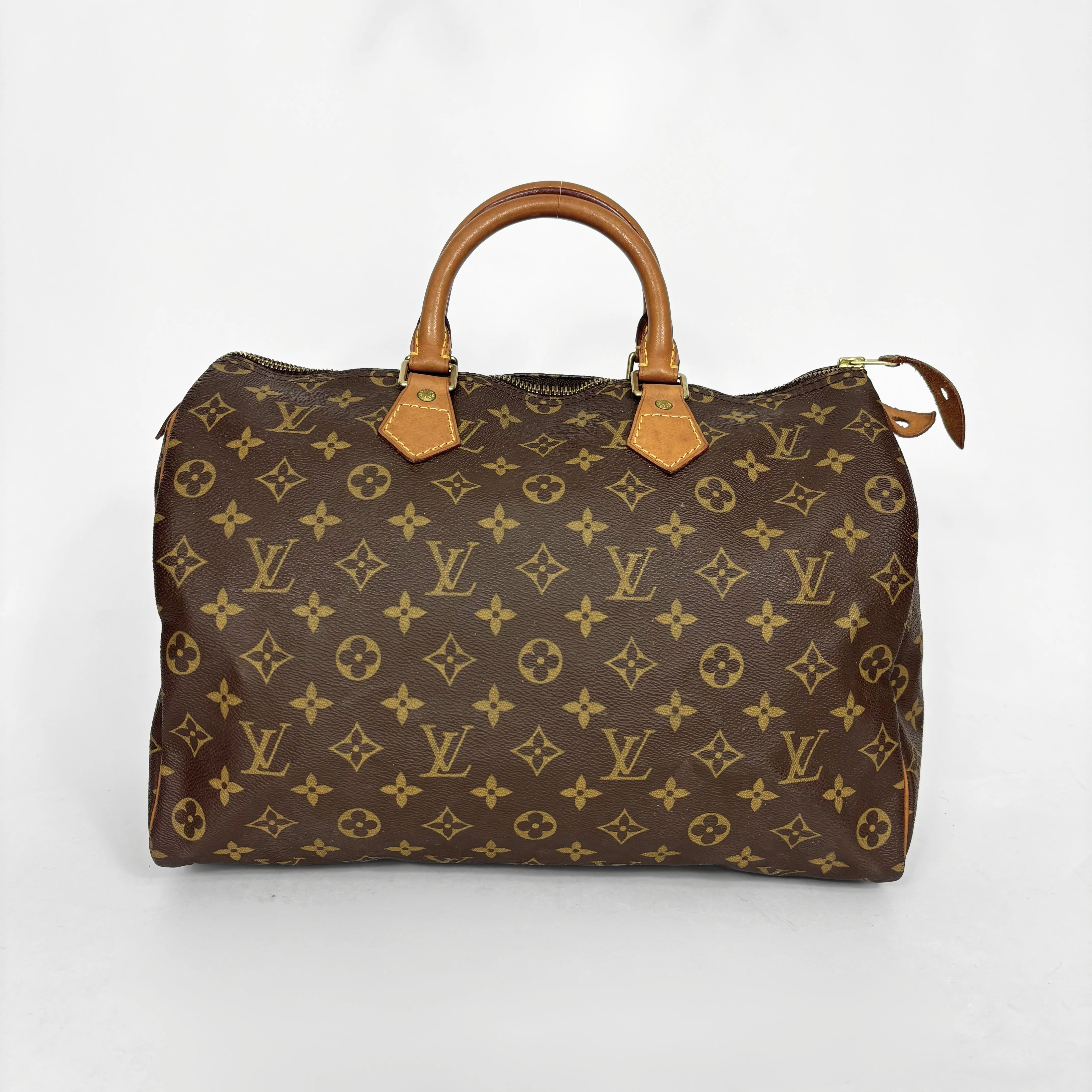 Brown handbag with a monogram pattern on a white background