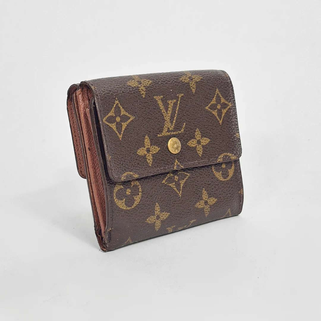 Louis Vuitton wallet with monogram pattern on a light gray background