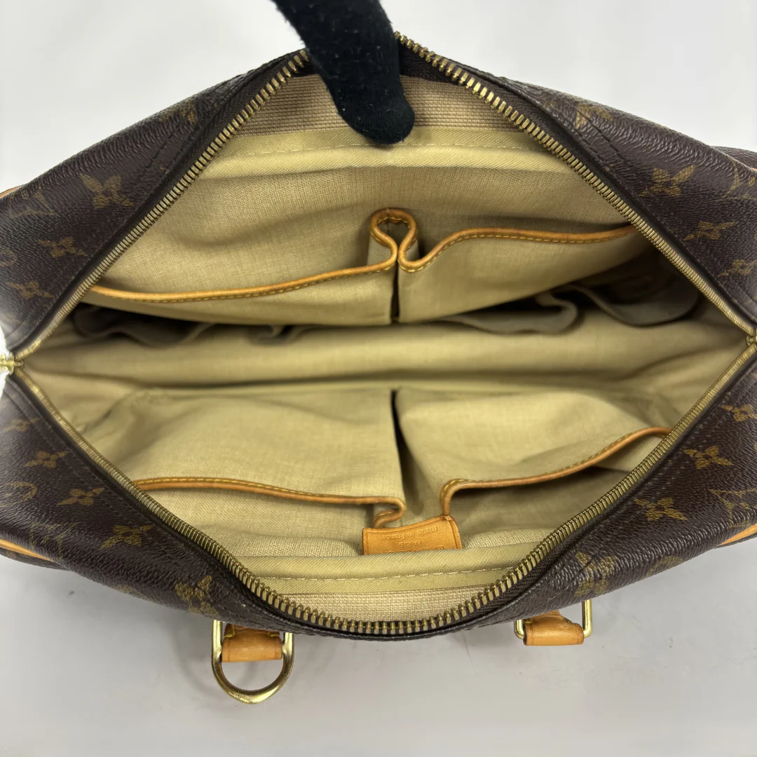 Designer handbag with monogram pattern on a white background