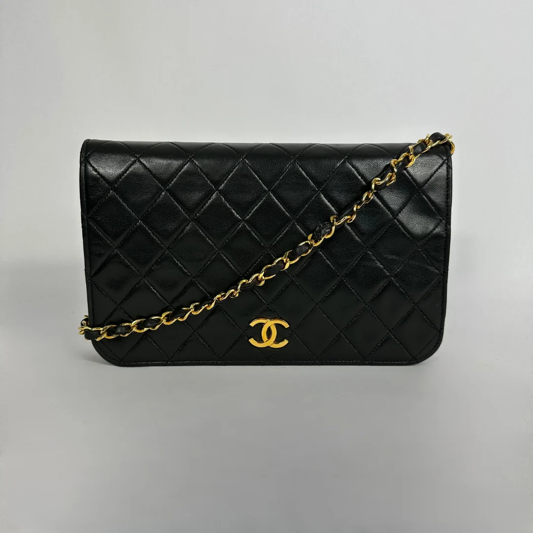 Black Chanel bag on white background