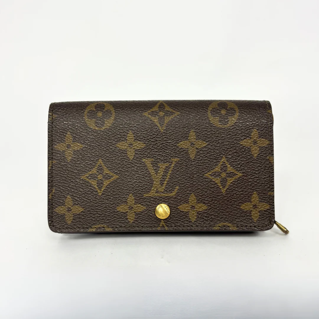 Louis Vuitton wallet with monogram pattern on a white background