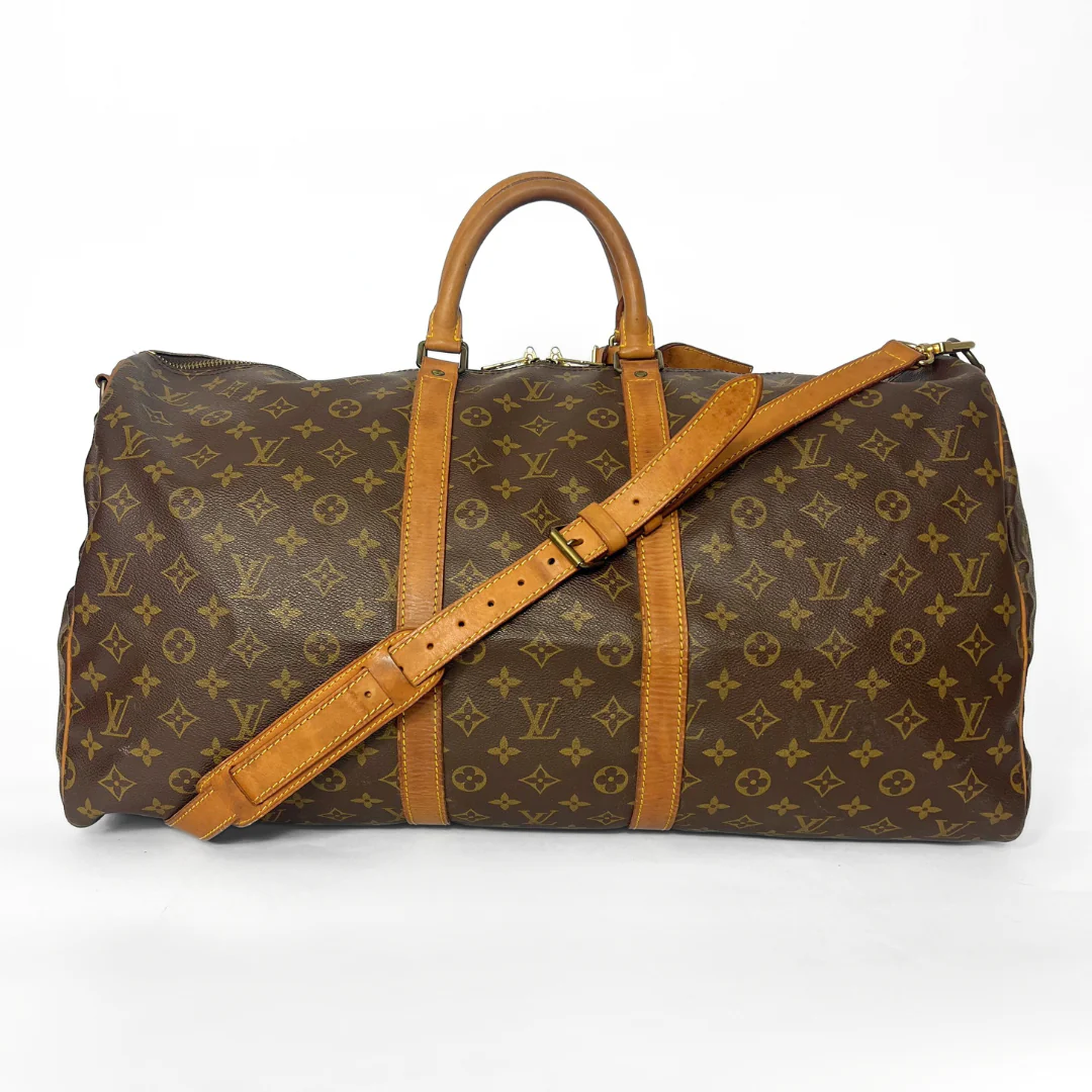 Brown travel bag with tan straps on a white background