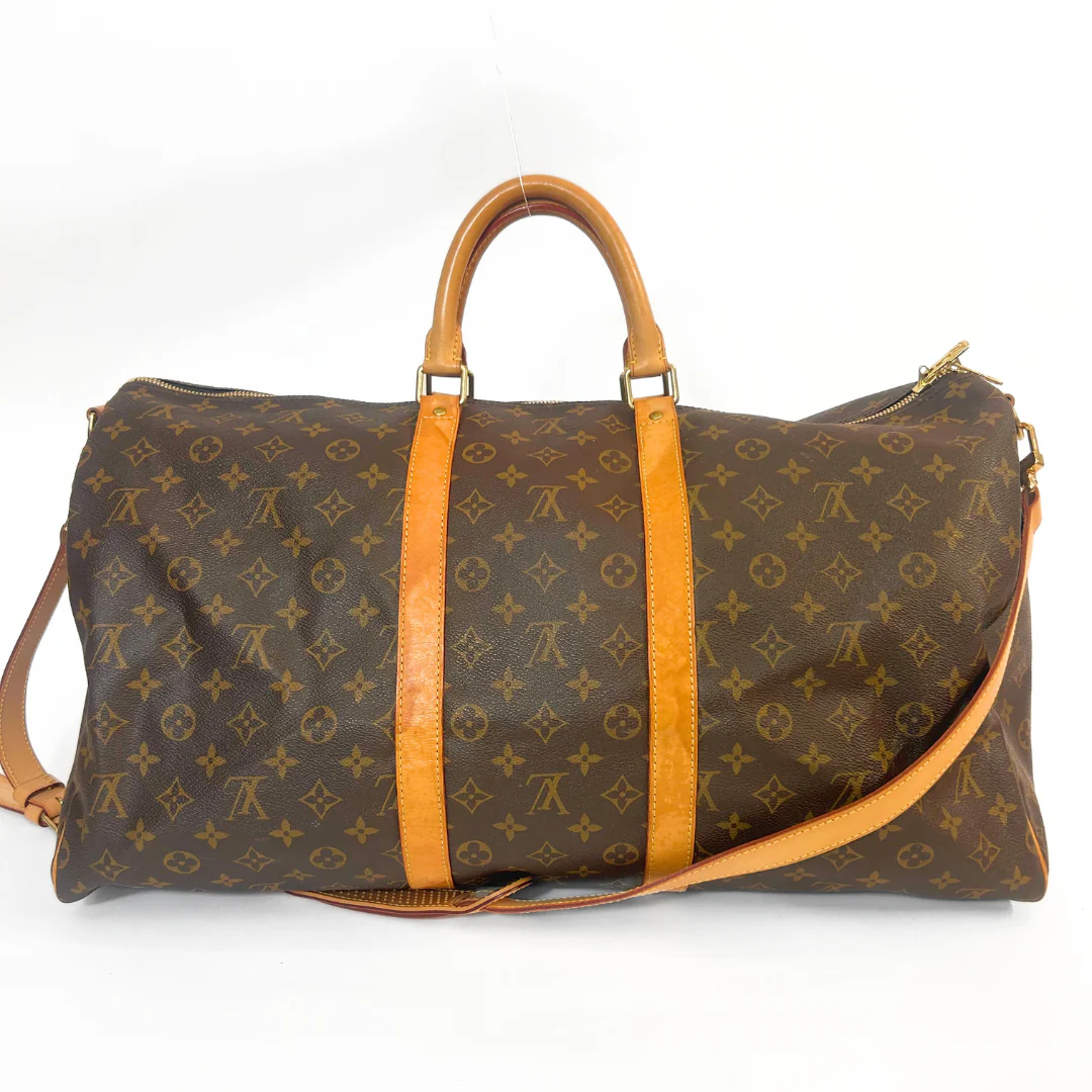 Brown duffel bag with orange accents on a white background