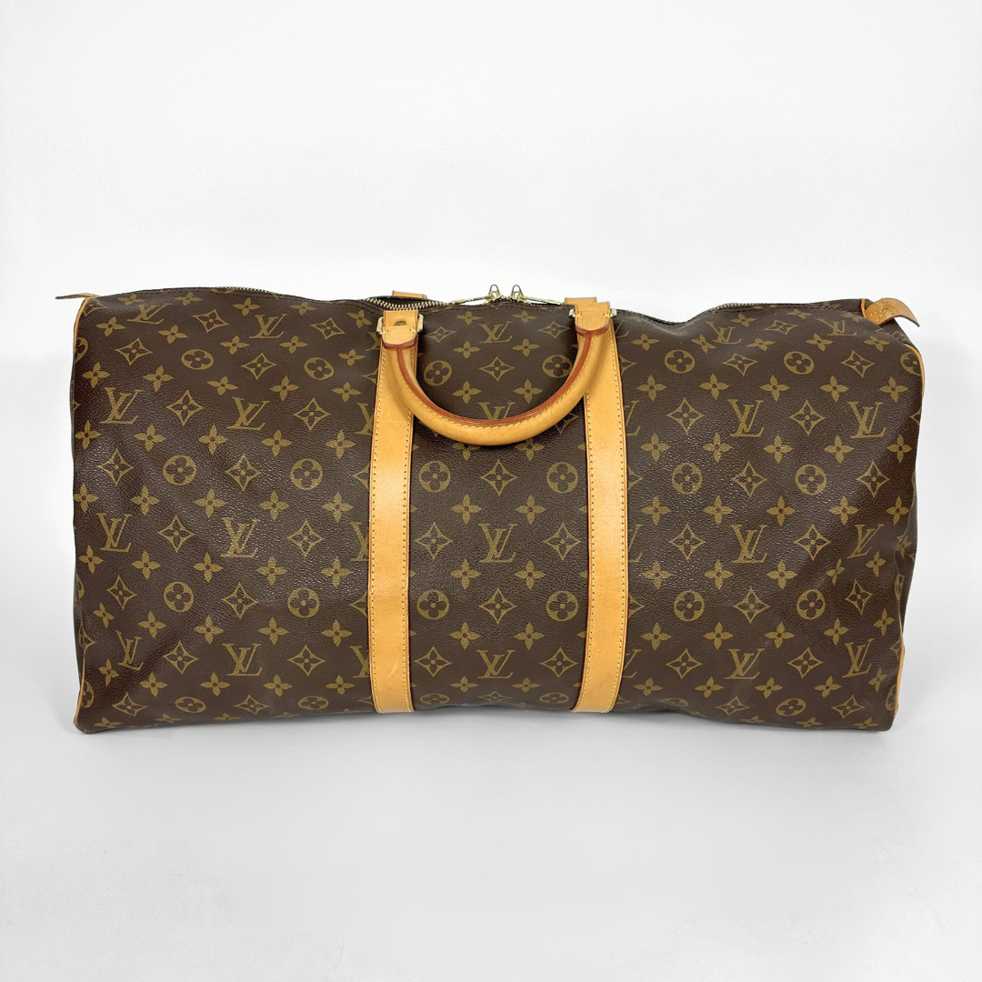 Louis Vuitton monogram duffel bag with tan handles on a white background