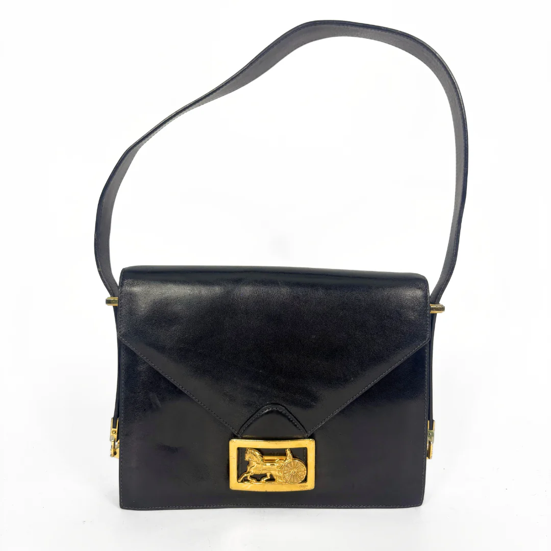 Celine vintage black leather shoulder bag with gold-tone horse and cariage buckle.