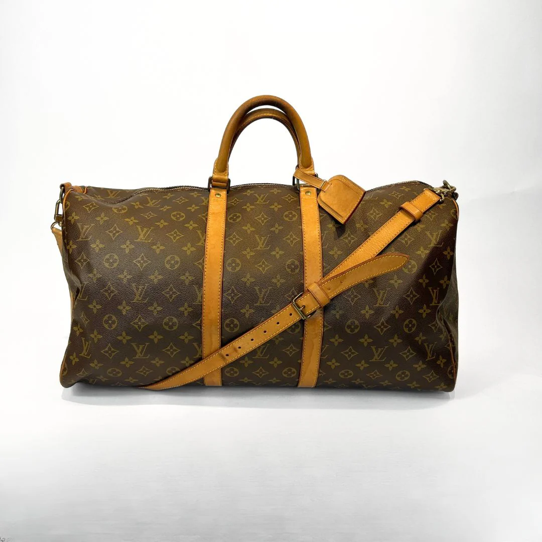 Brown travel bag with tan straps on a white background