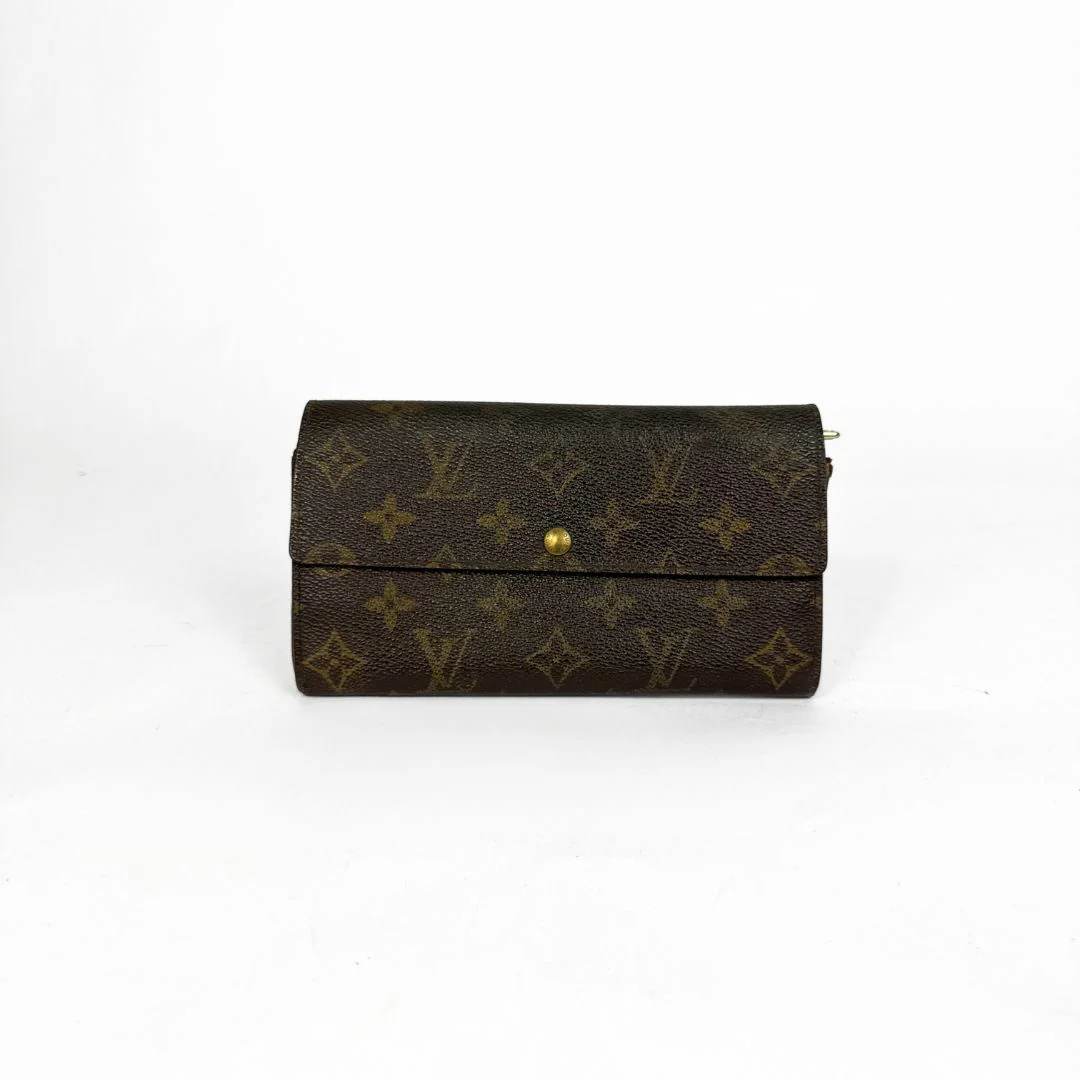 Louis Vuitton wallet with monogram pattern on a white background