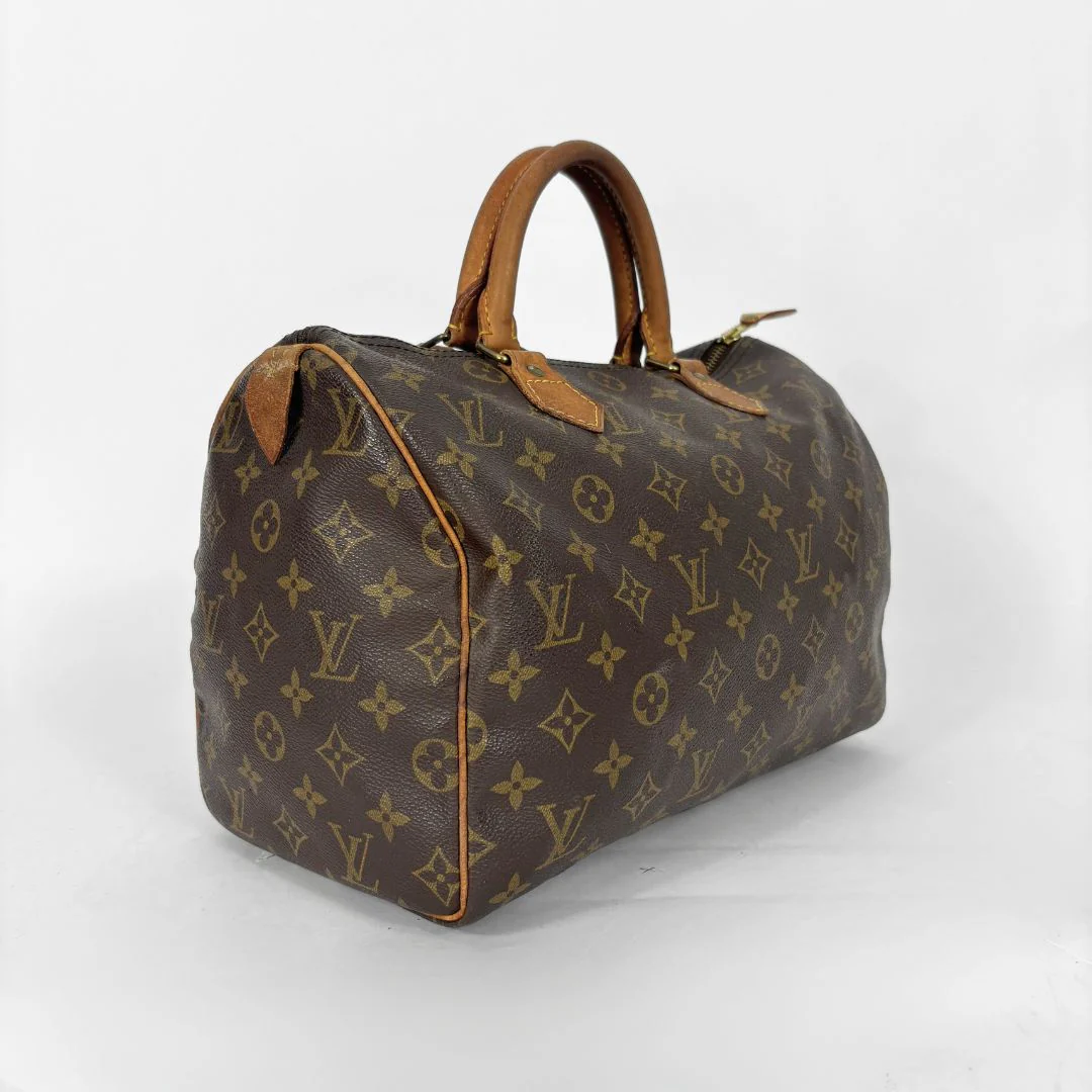 Brown handbag with monogram pattern on a white background