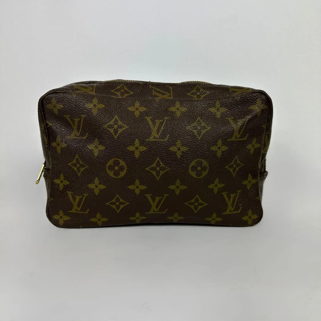 Louis Vuitton toiletry bag in front of white background