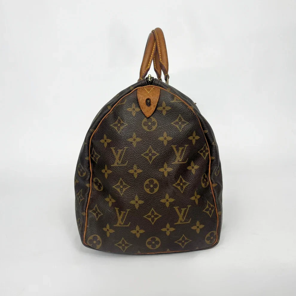 Brown Louis Vuitton bag with monogram pattern on a white background