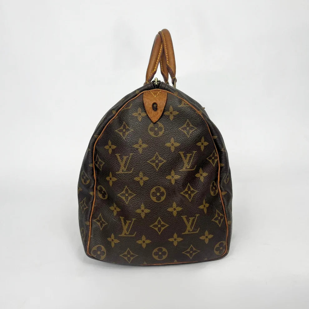 Brown Louis Vuitton bag with monogram pattern on a white background