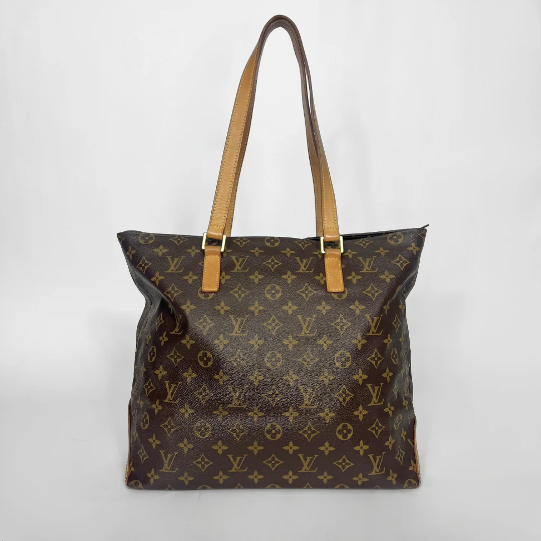 Brown monogram handbag with tan straps on a white background
