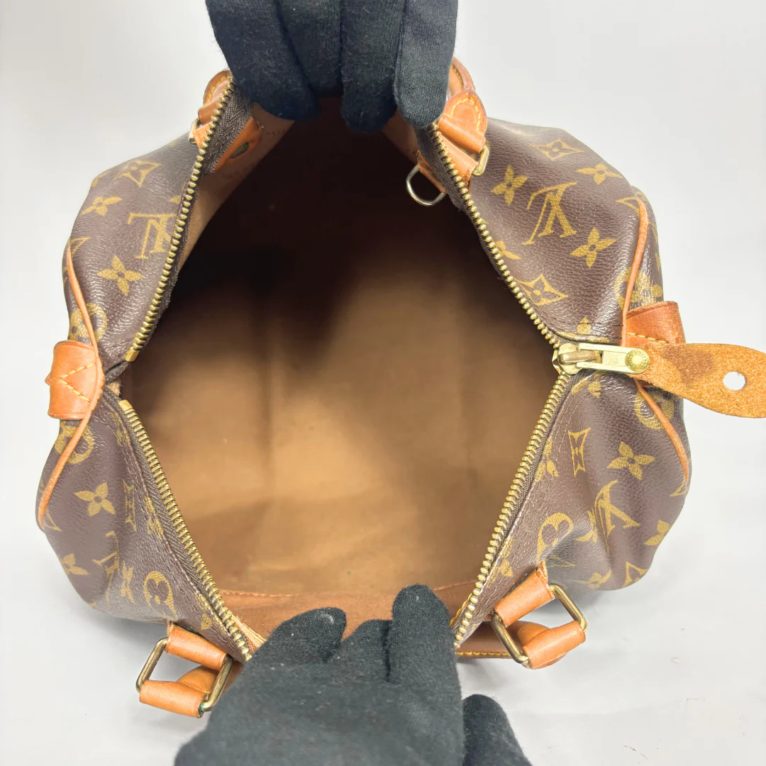 Brown Louis Vuitton handbag with monogram pattern on a white background