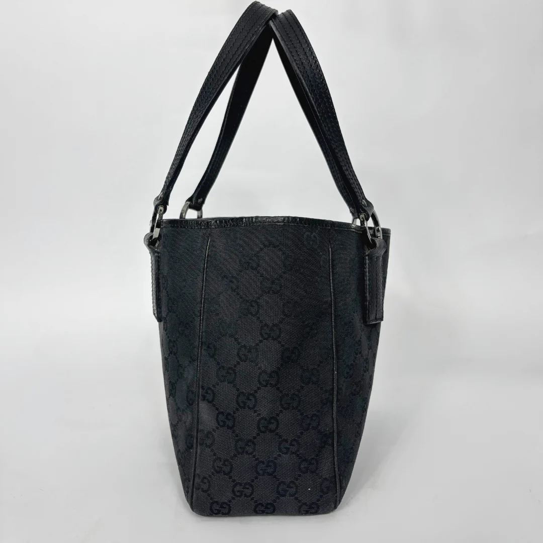 Black patterned handbag on a white background