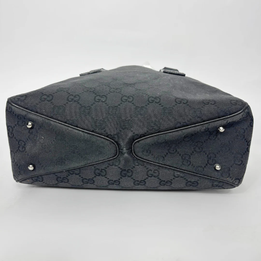 Black patterned handbag on a white background
