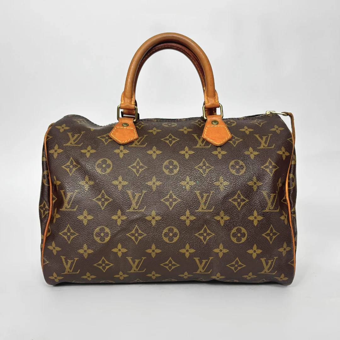 Designer handbag with monogram pattern on a white background