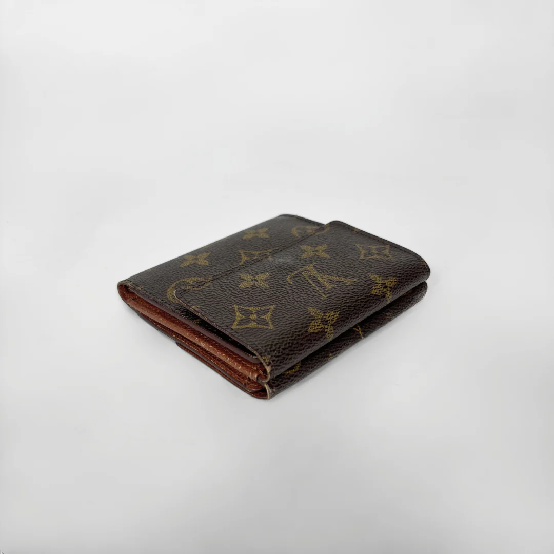 Brown leather wallet with monogram pattern on a light gray background