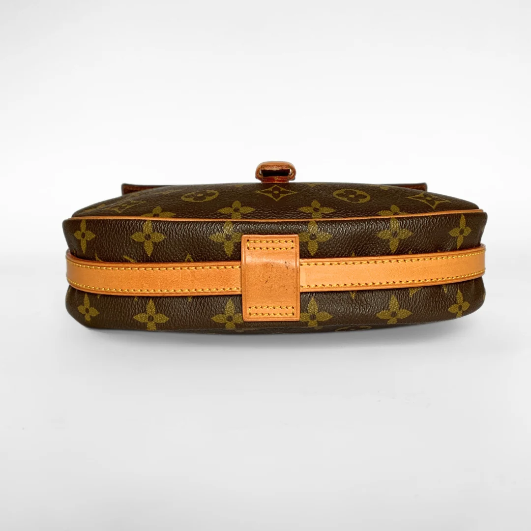 Brown monogram handbag with tan strap on a white background
