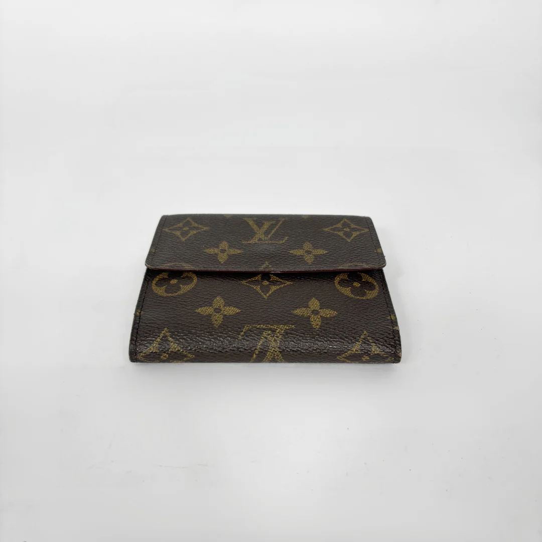 Louis Vuitton wallet with monogram pattern on a white background