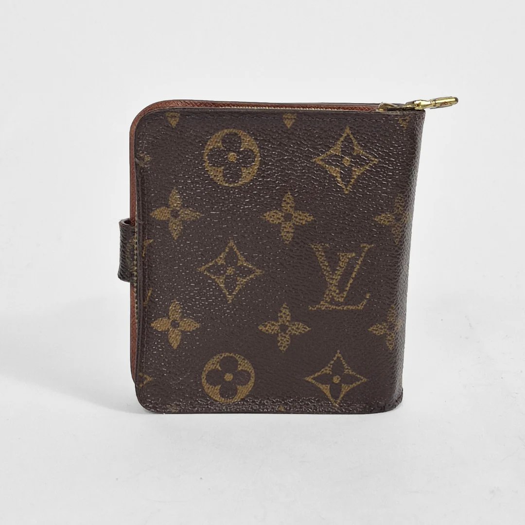 Brown wallet with gold monogram pattern on a white background