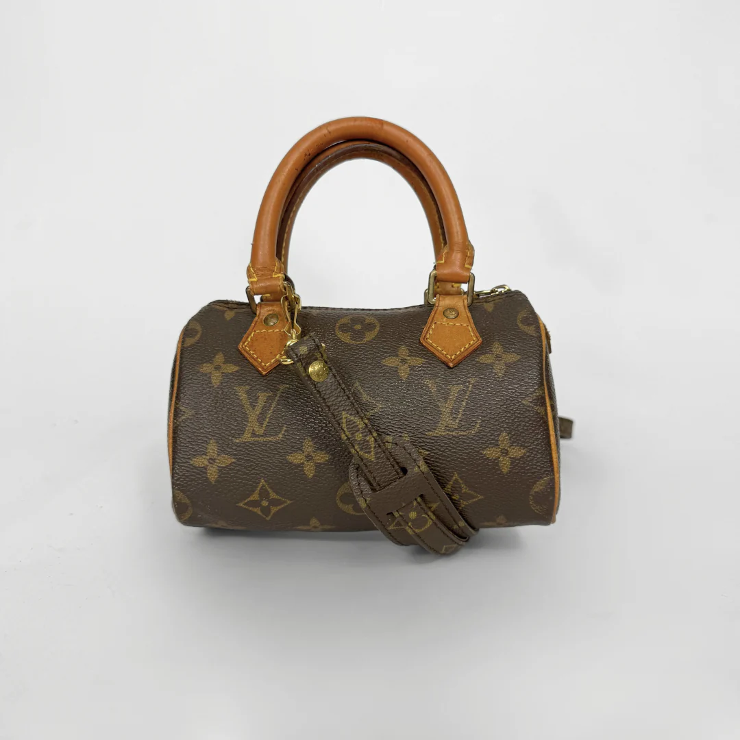 Brown handbag with monogram pattern on a white background