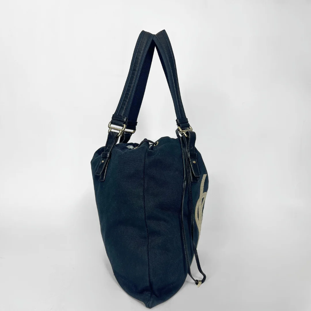 Navy blue handbag with a white logo on a white background