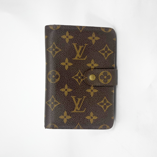 Brown wallet with gold monogram pattern on a white background
