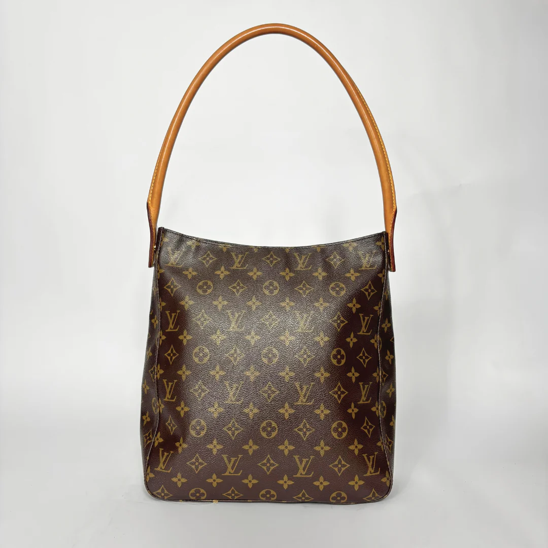 Designer handbag with monogram pattern on a light gray background