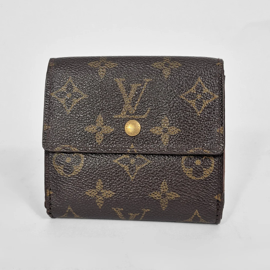 Louis Vuitton wallet with monogram pattern on a light gray background