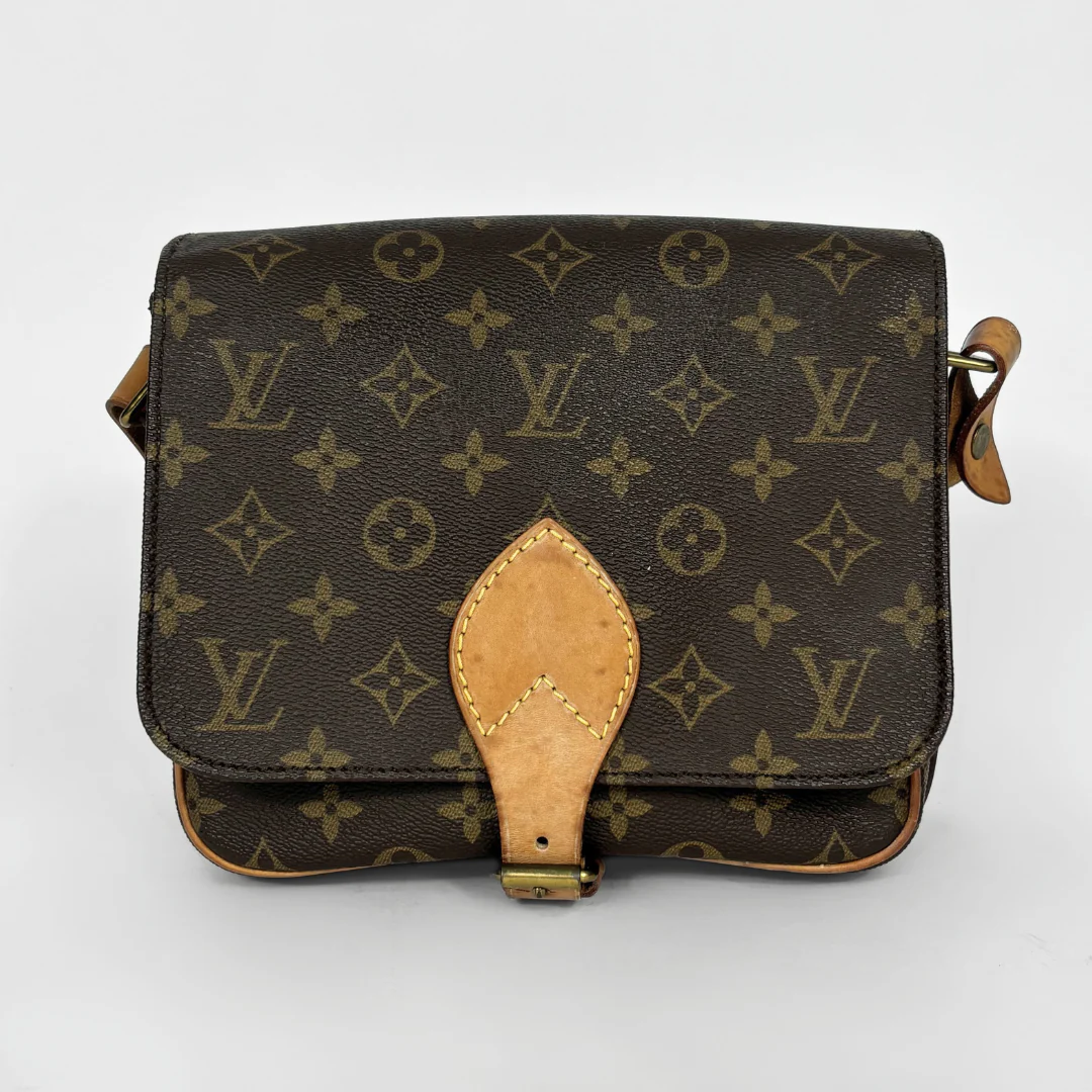 Louis Vuitton monogram handbag on a light gray background