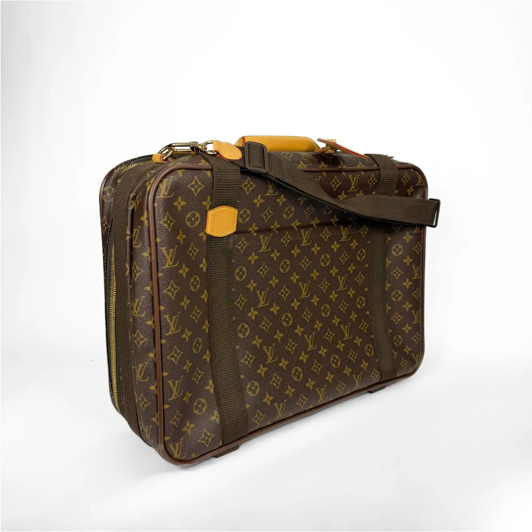 Brown patterned suitcase with a shoulder strap on a white background